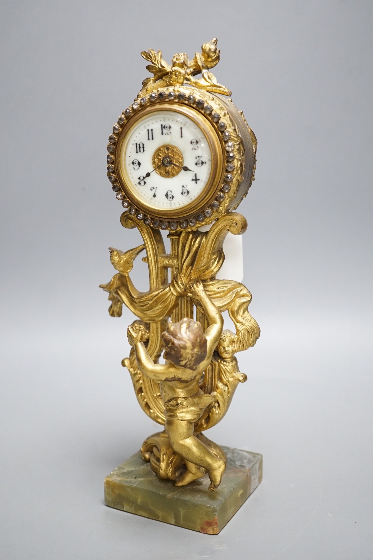 An early 20th century gilt metal cherubic mantel timepiece on onyx base, 29cm